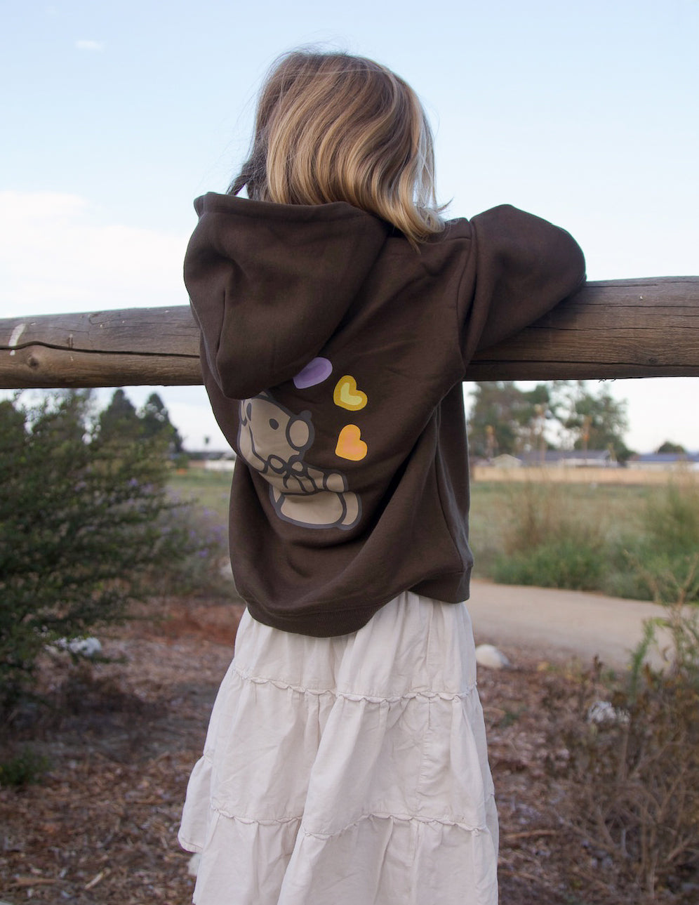 Kids hoodie in dark brown with back cartoon bear and heart accents, rear view