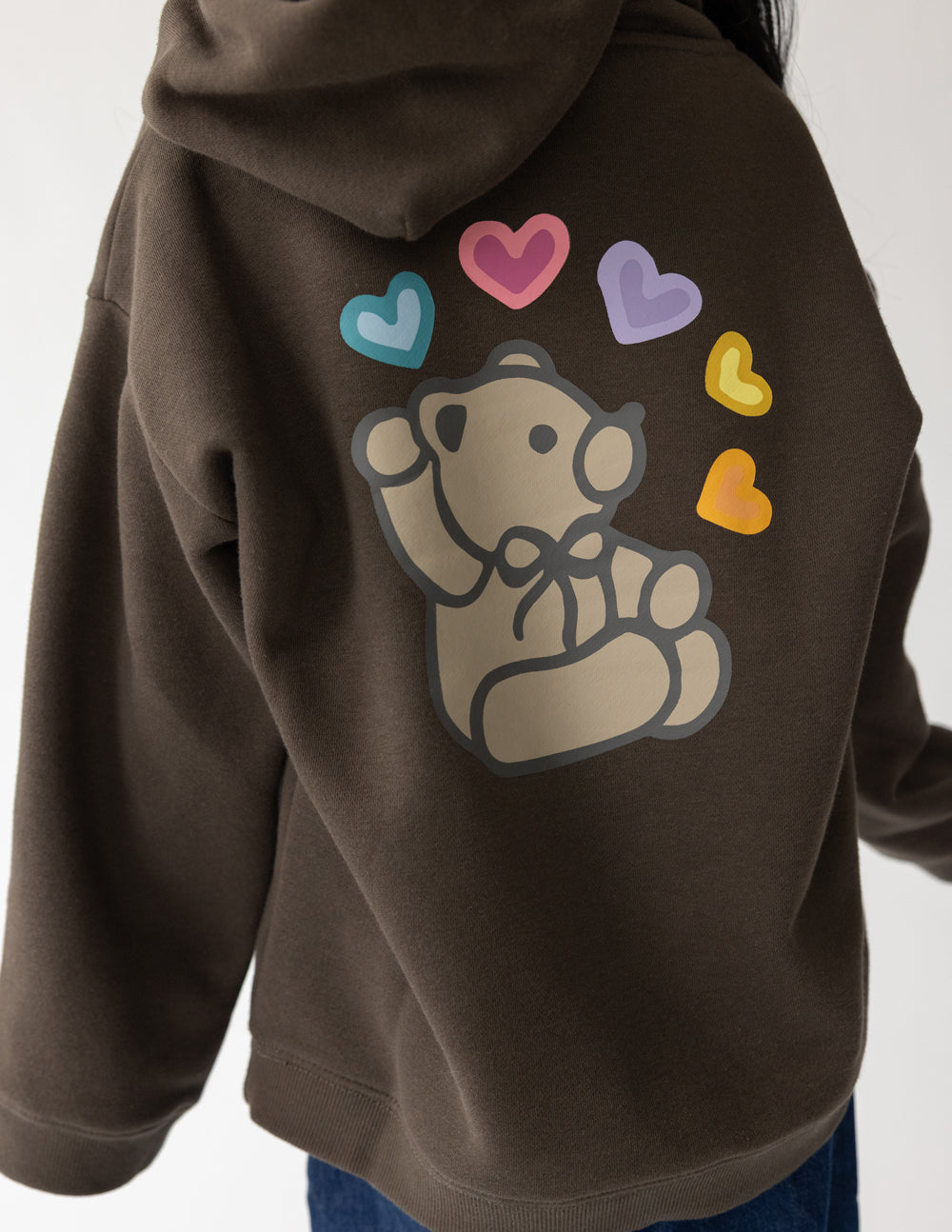 Kids hoodie in dark brown with large back cartoon bear graphic and multicolor hearts
