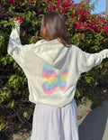 Unisex light-colored hoodie with rainbow heart butterfly graphic on back