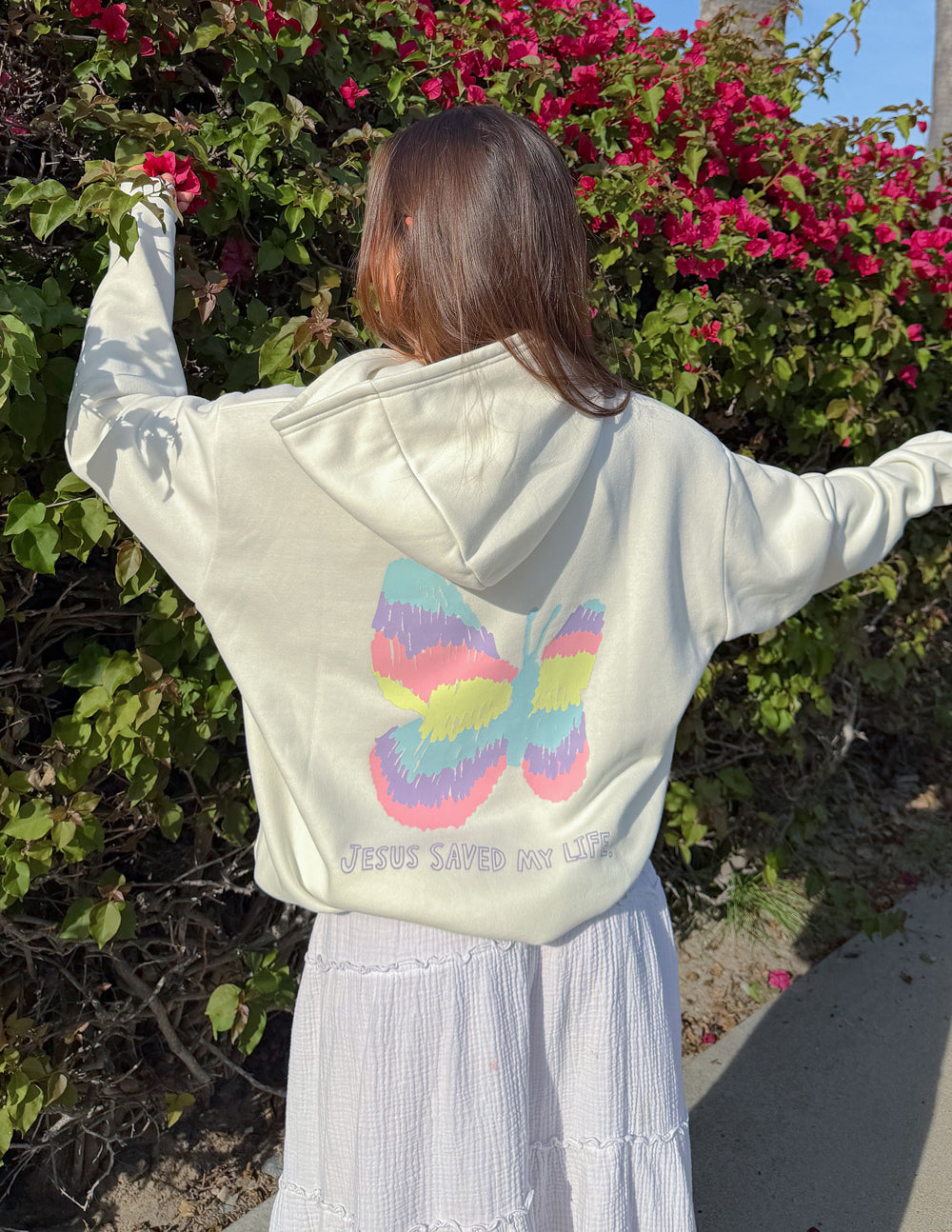 Unisex light-colored hoodie with rainbow heart butterfly graphic on back