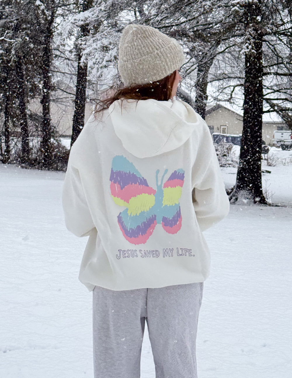 Unisex light hoodie with rainbow butterfly graphic on back, hood up