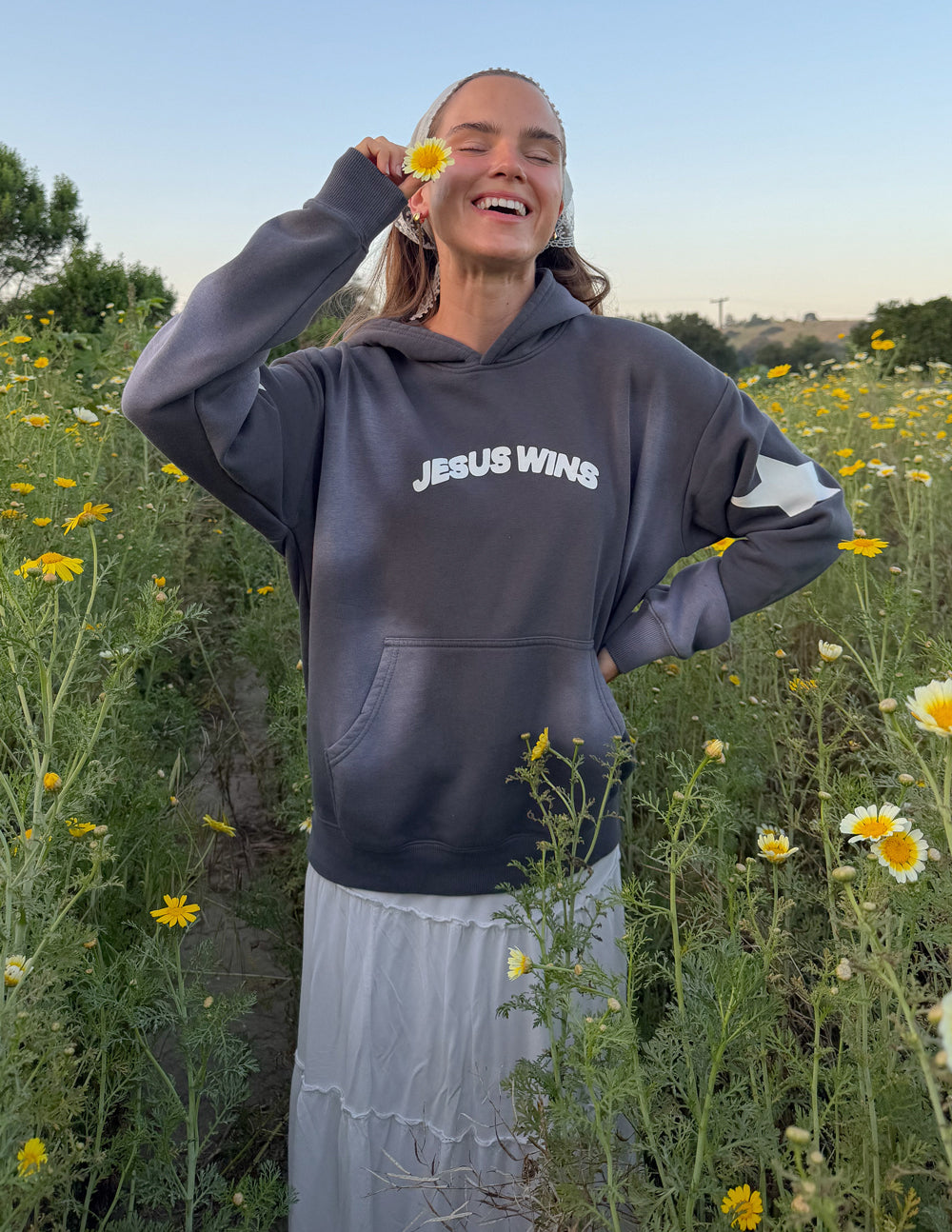 Dark gray unisex hoodie with 'JESUS WINS' chest print and hood.