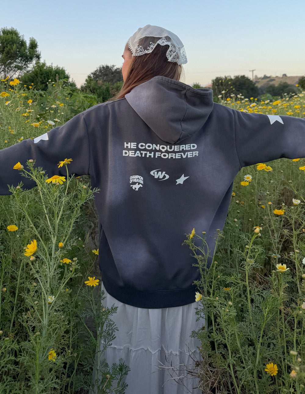 Dark gray unisex hoodie with 'HE CONQUERED DEATH FOREVER' back print and hood.