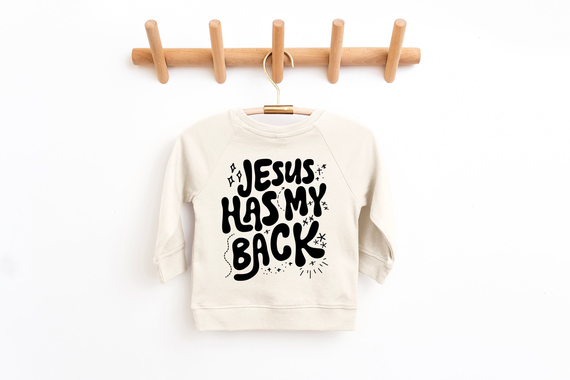 Toddler pullover sweatshirt in off-white with "Jesus has my back" graphic front
