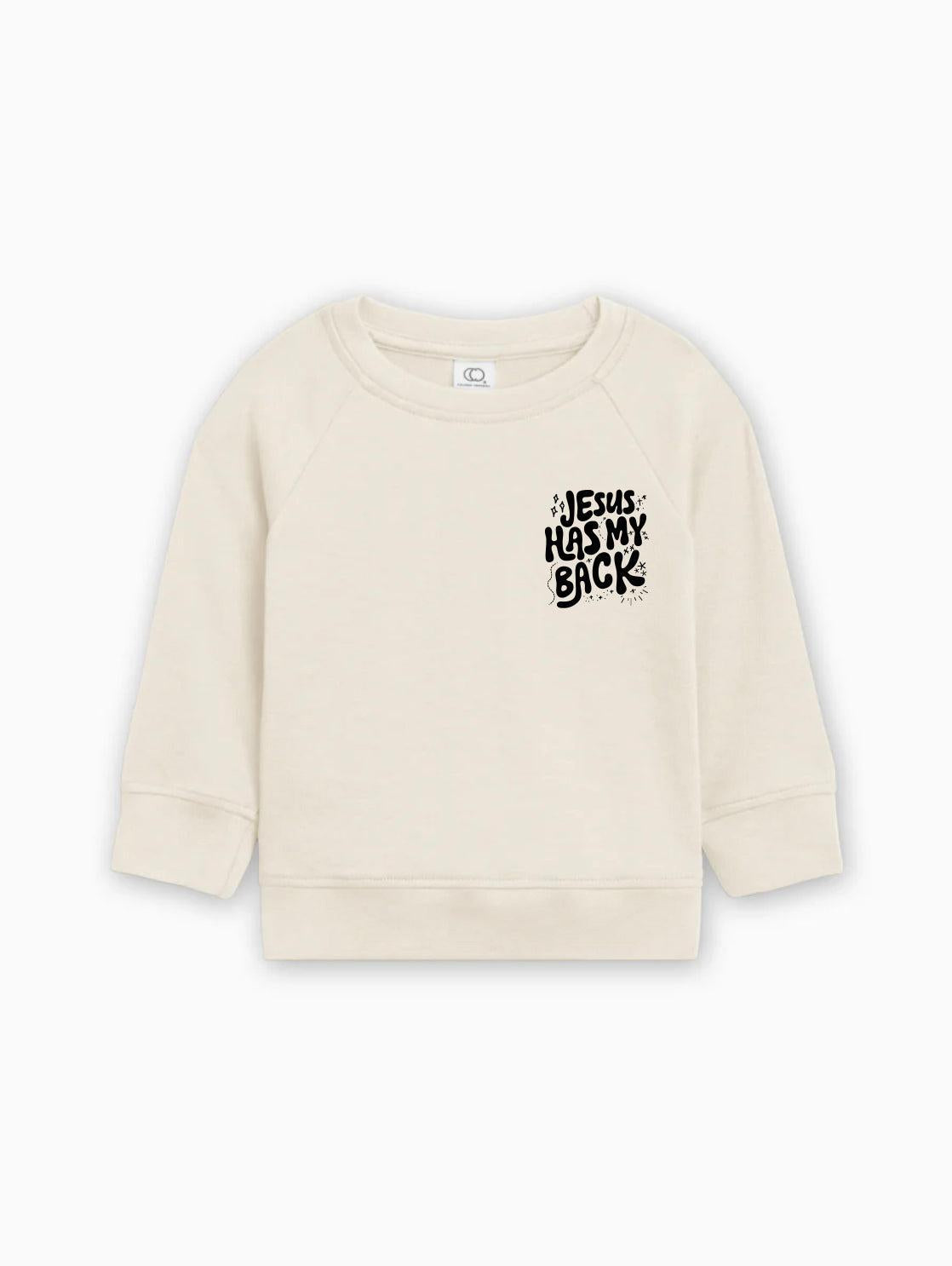 Toddler pullover sweatshirt in light cream with "Jesus has my back" graphic