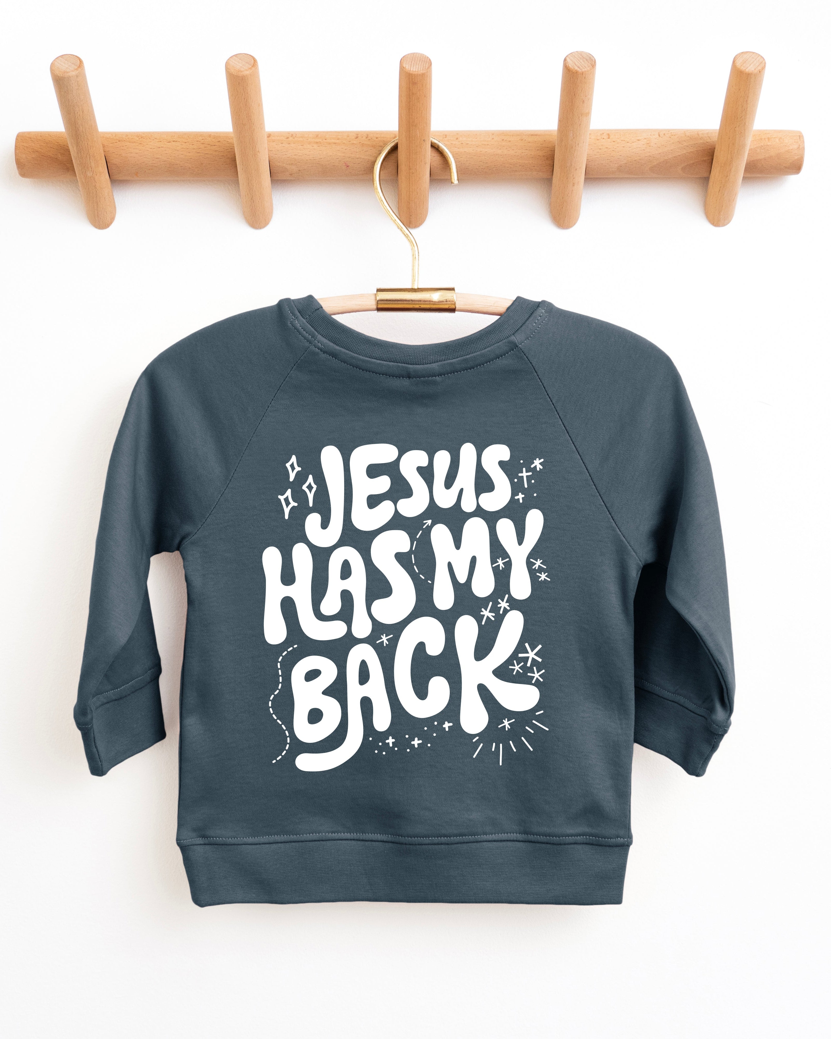 Toddler pullover sweatshirt in dark teal with "Jesus has my back" graphic front