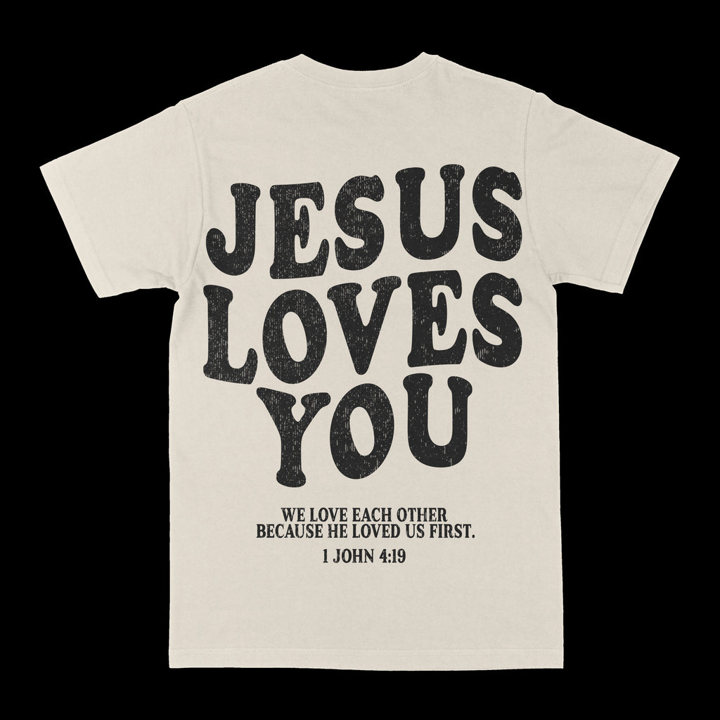 Cream/light graphic crewneck tee with large distressed "JESUS LOVES YOU" and verse text