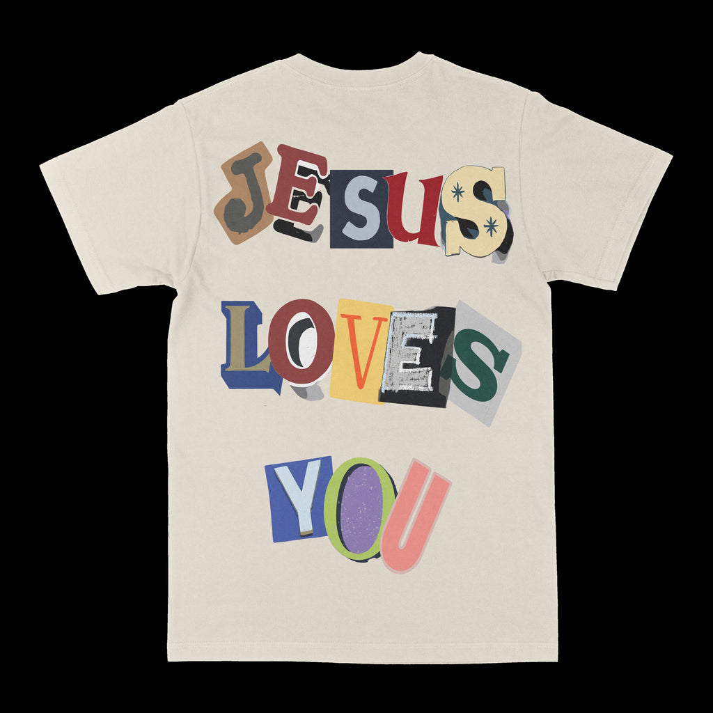 Cream graphic T-shirt with large colorful 'Jesus Loves You' text