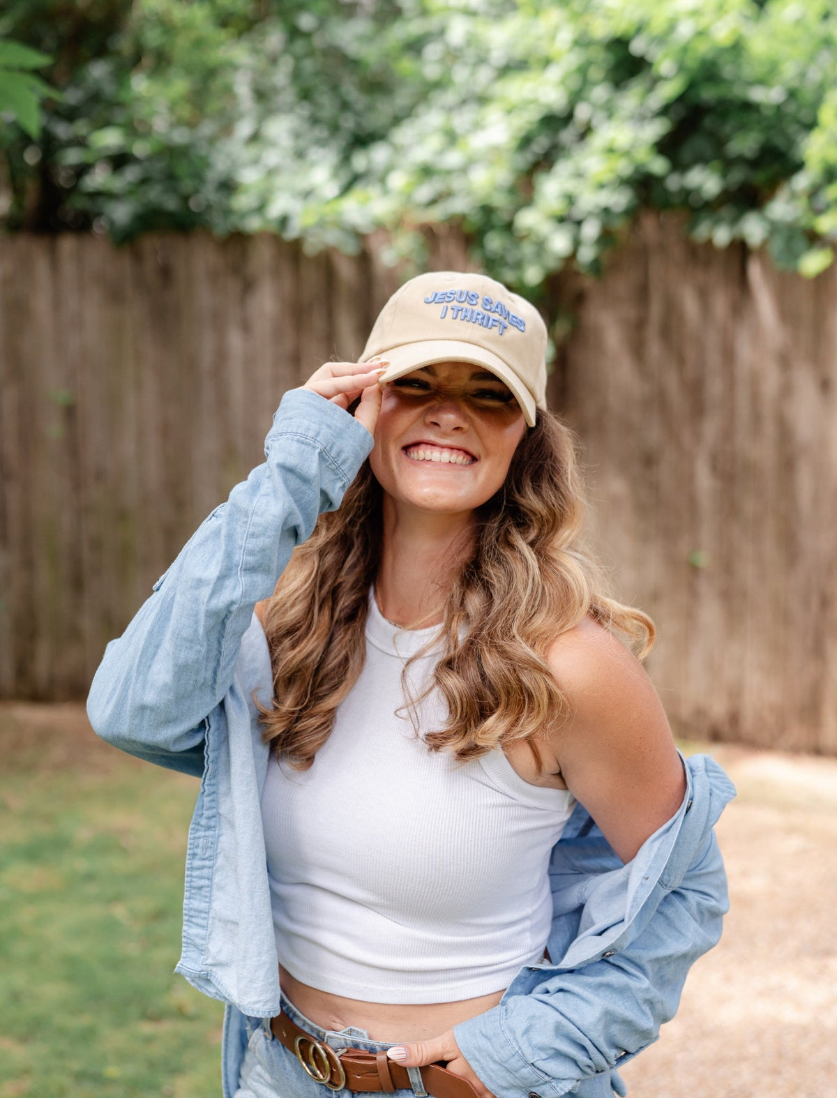Light beige baseball cap with blue “Jesus Saves I Thrift” logo on front panel