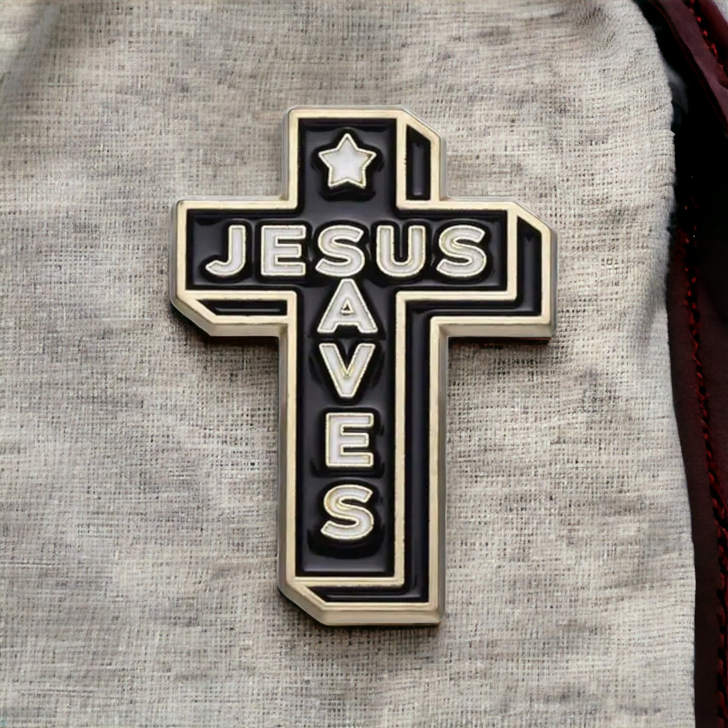 Cross enamel pin on light gray fabric, black with gold trim, “JESUS SAVES”