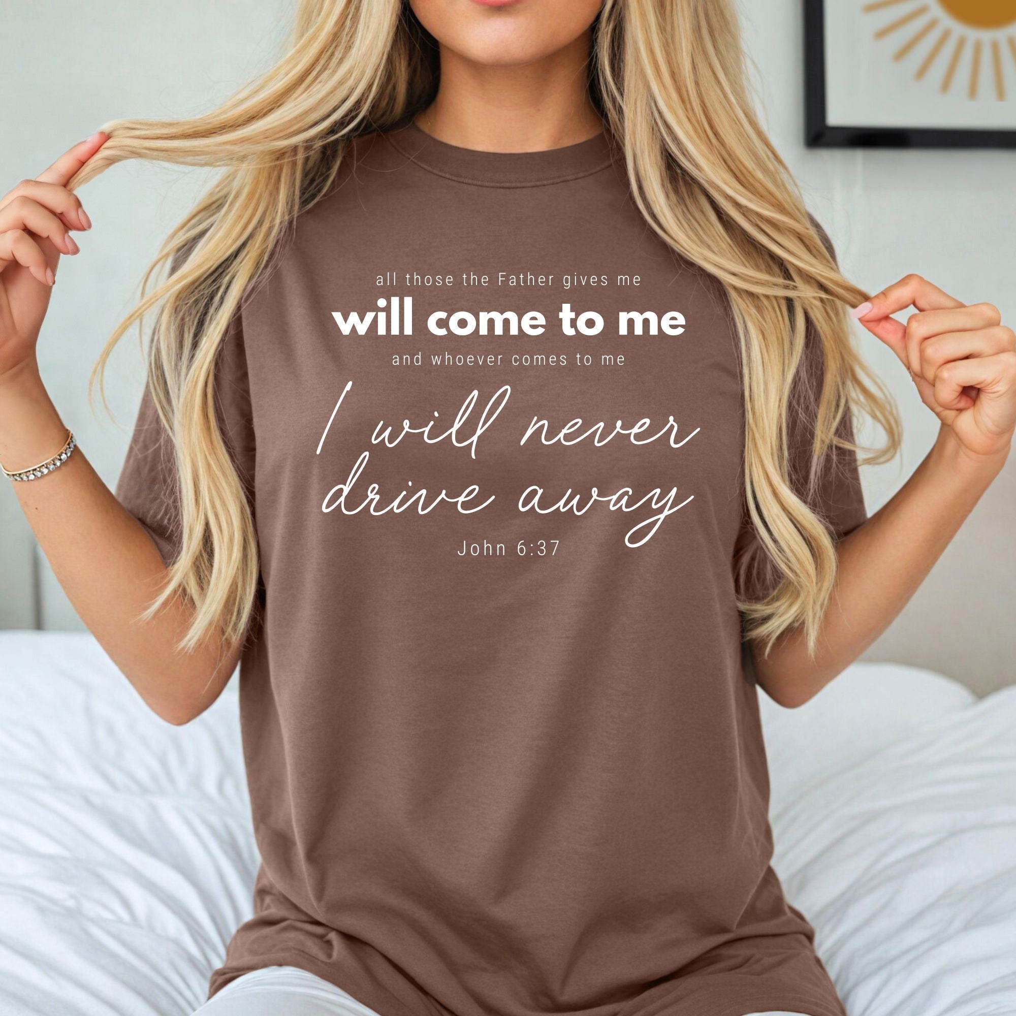 Dark brown crew-neck T-shirt with white quote text and script graphic
