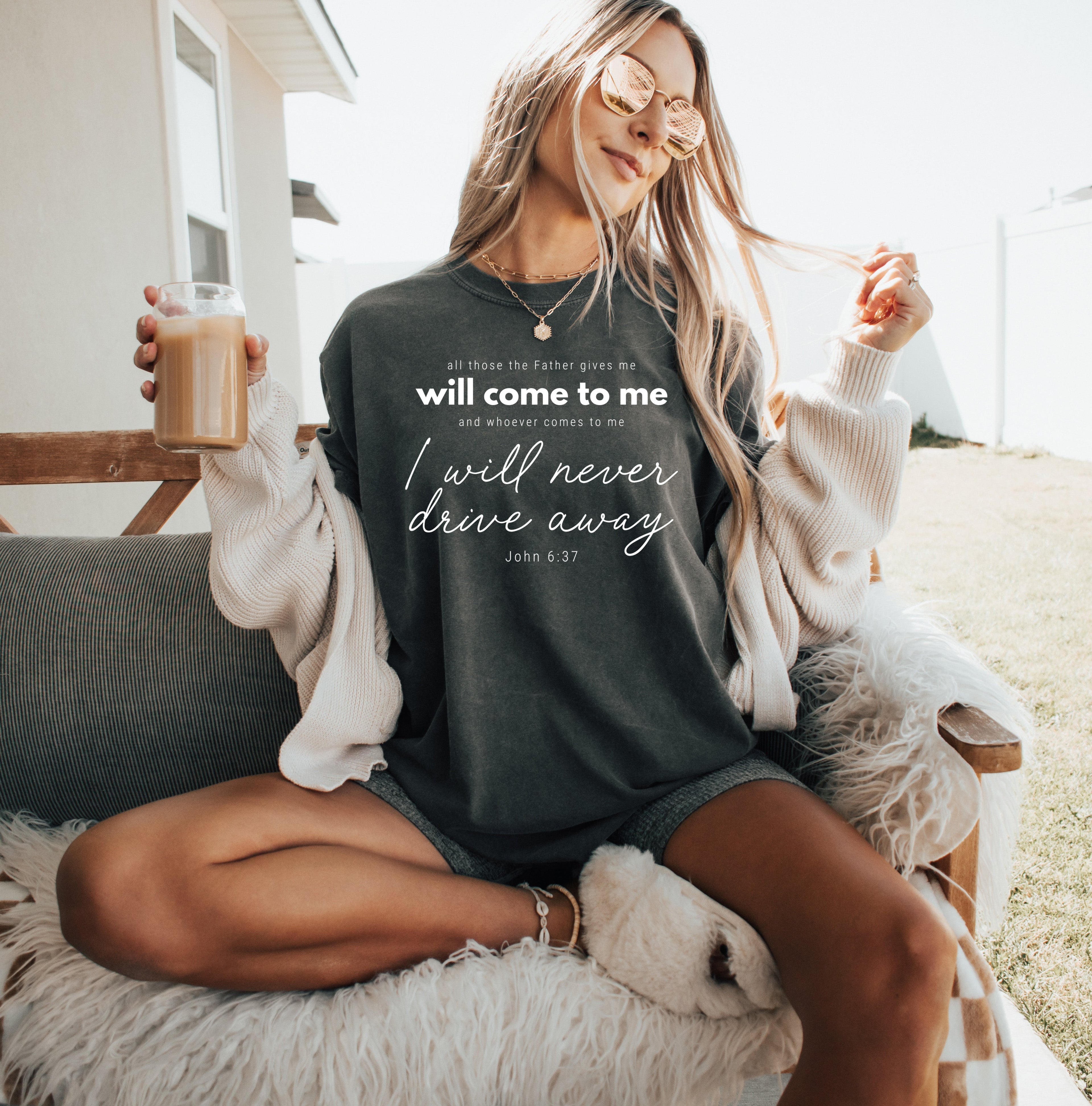 Charcoal crew-neck T-shirt with white quote text and script graphic