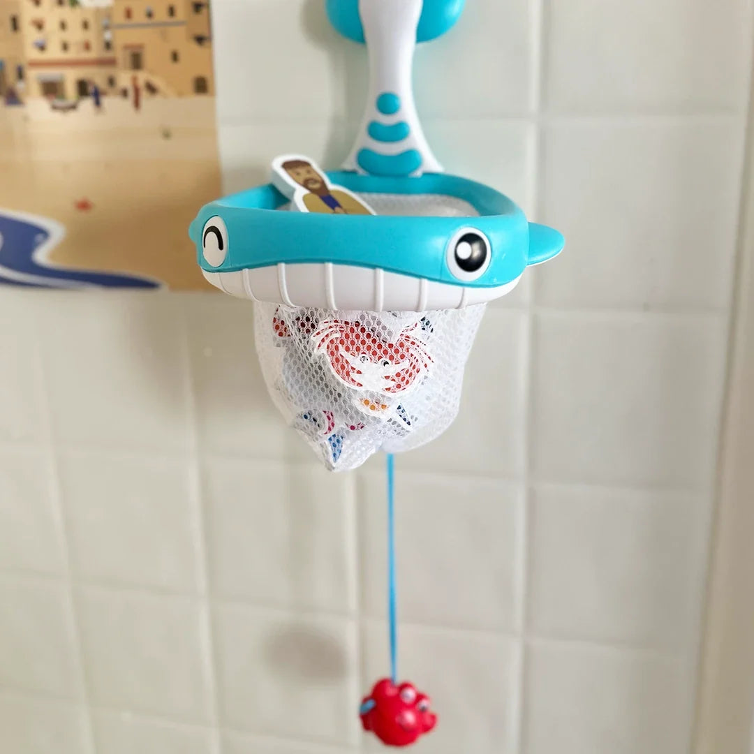 Blue dolphin bath net toy with mesh pouch and dangling red crab