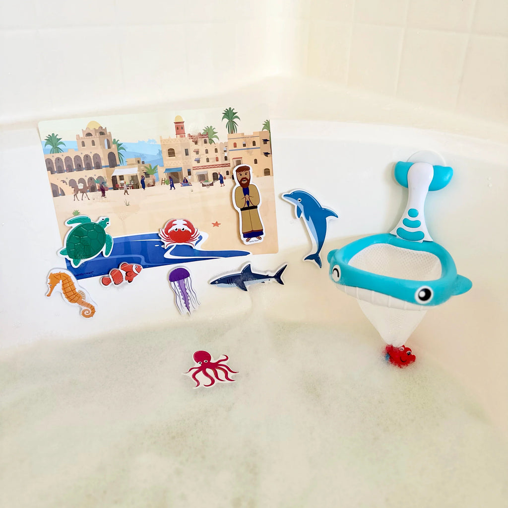 Blue dolphin bath net toy with mesh pouch and ocean animal sticker pieces in tub