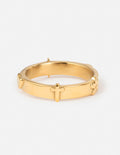 Gold ring with raised cross detail on the band
