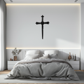 Black barbed wire cross metal wall art on smooth wall