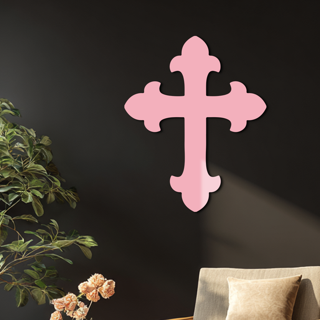 Pink metal cross wall art on a dark wall.