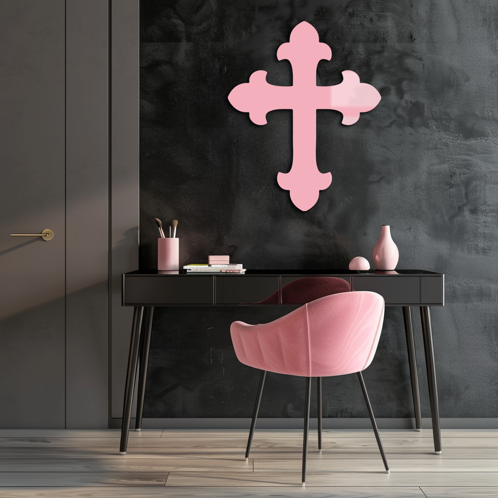 Pink metal cross wall art with rounded arms on a dark background.