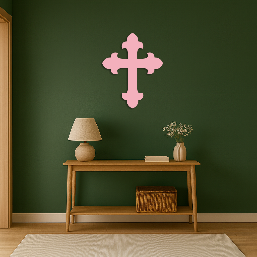 Pink metal cross wall art with rounded four-arm silhouette and vertical center