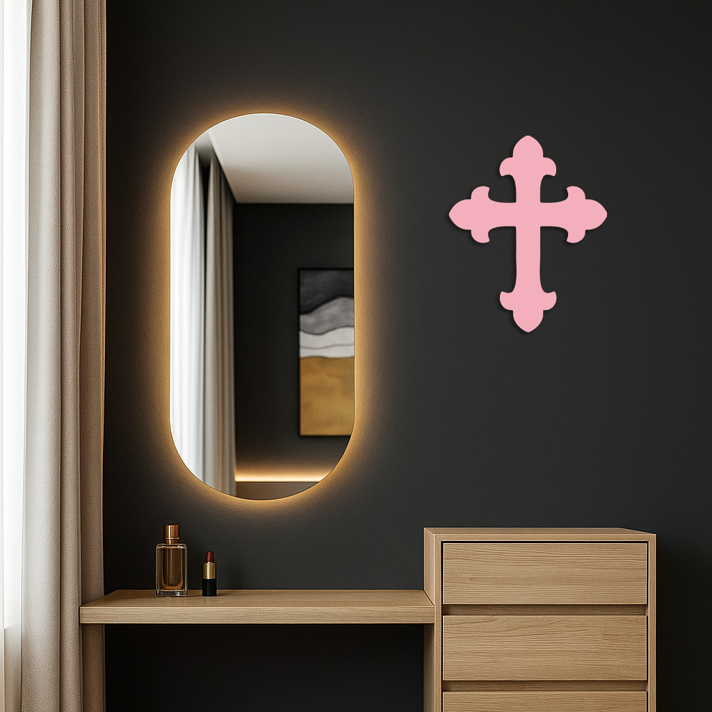 Pink metal cross wall art mounted on a dark wall.