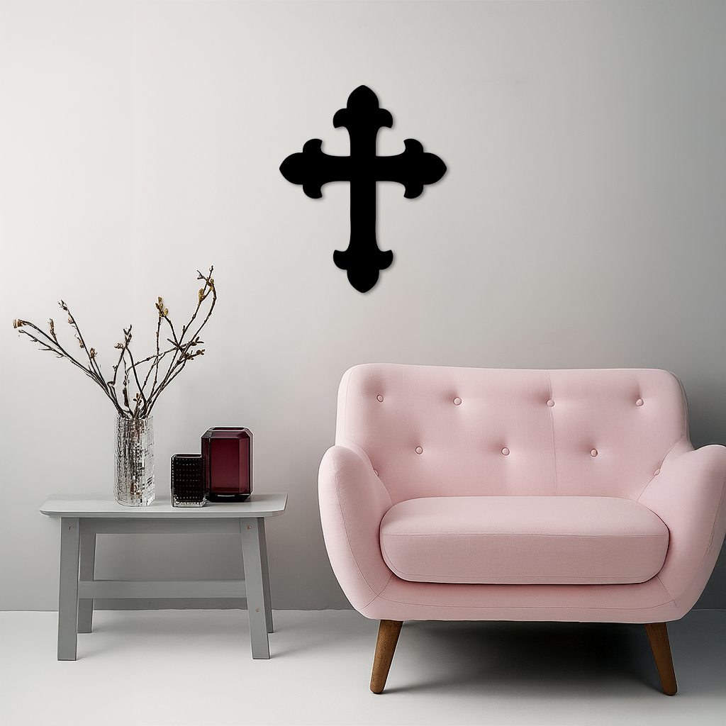 Black metal cross wall art on a light wall.