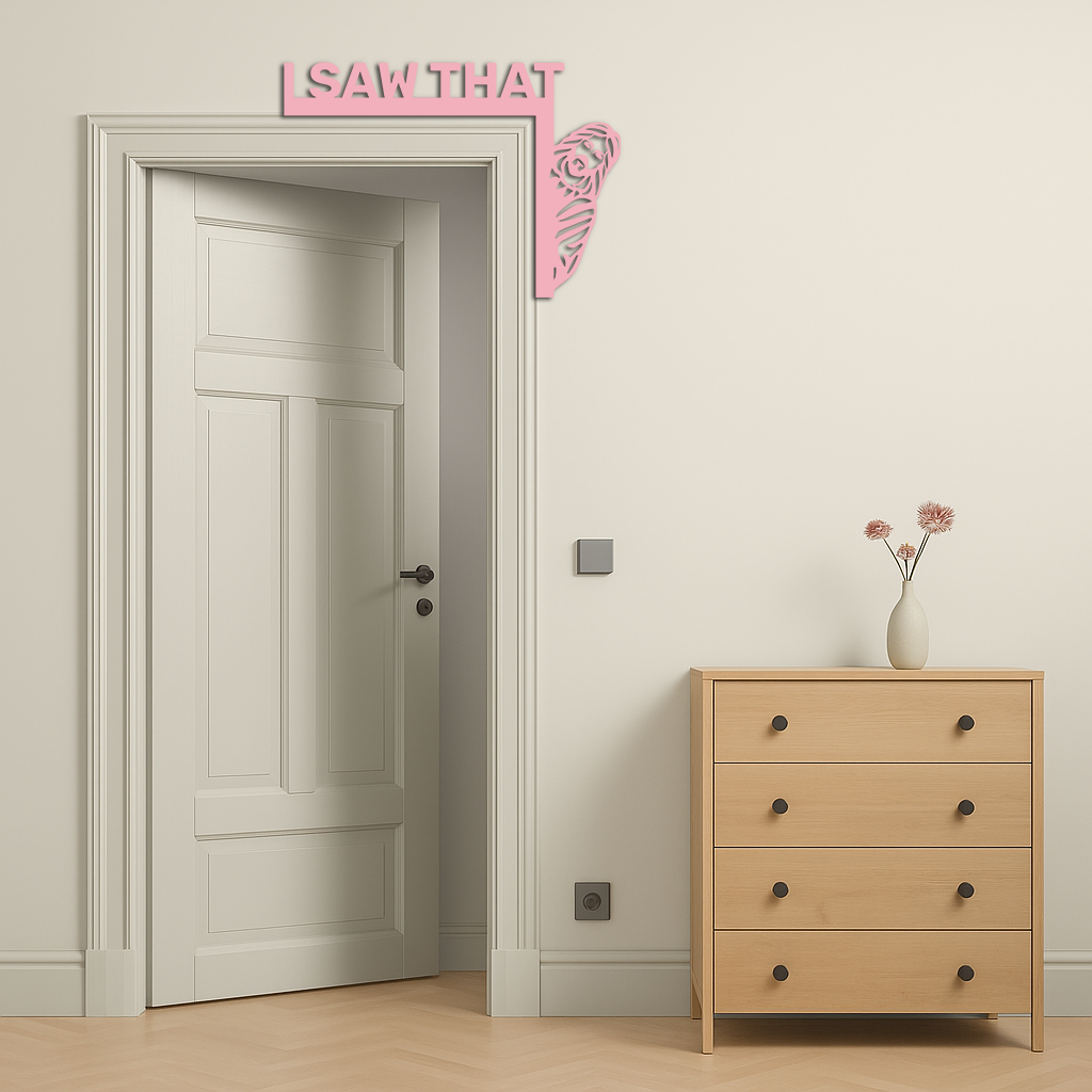 Pink corner metal wall art with 'I SAW THAT' text and rose swirl at door corner