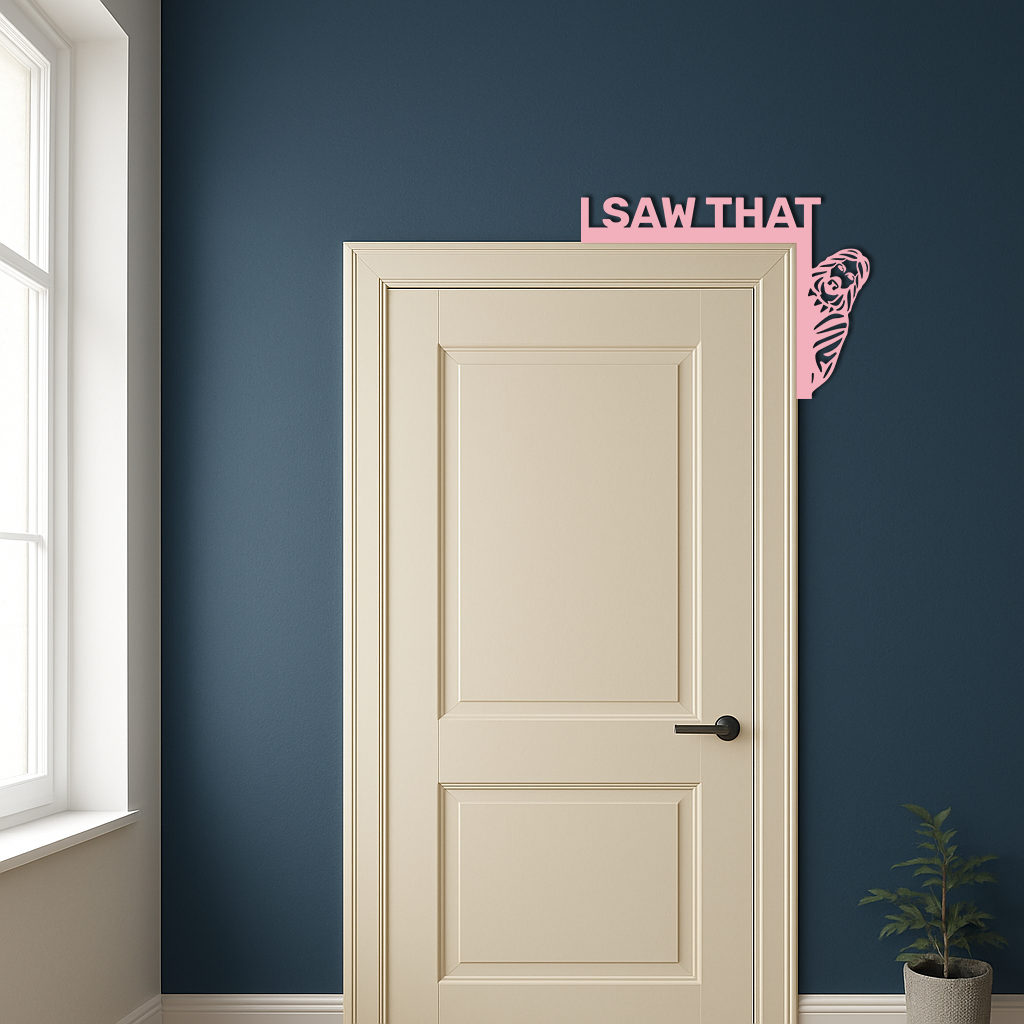 Pink corner metal wall art with 'I SAW THAT' text and rose swirl by cream door