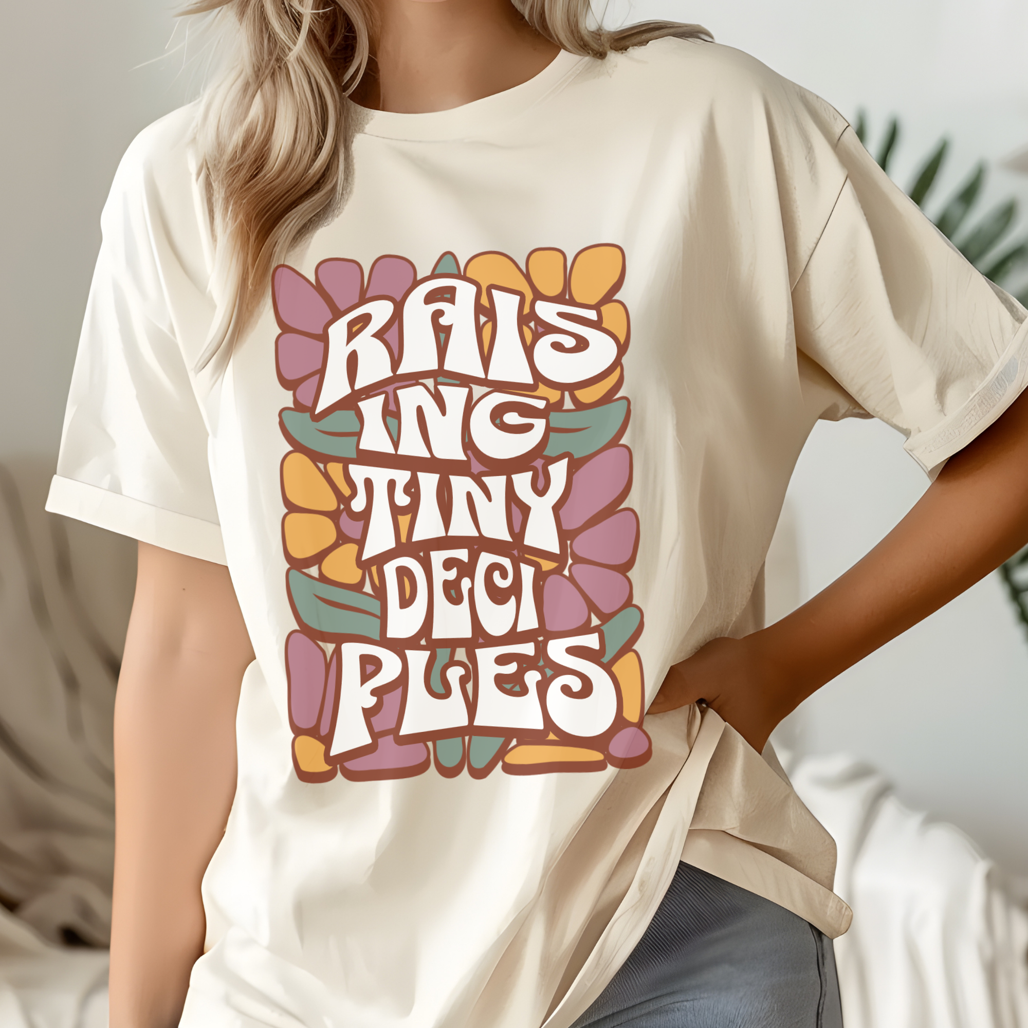 Cream long-sleeve crewneck shirt with colorful 'RAISING TINY...' graphic