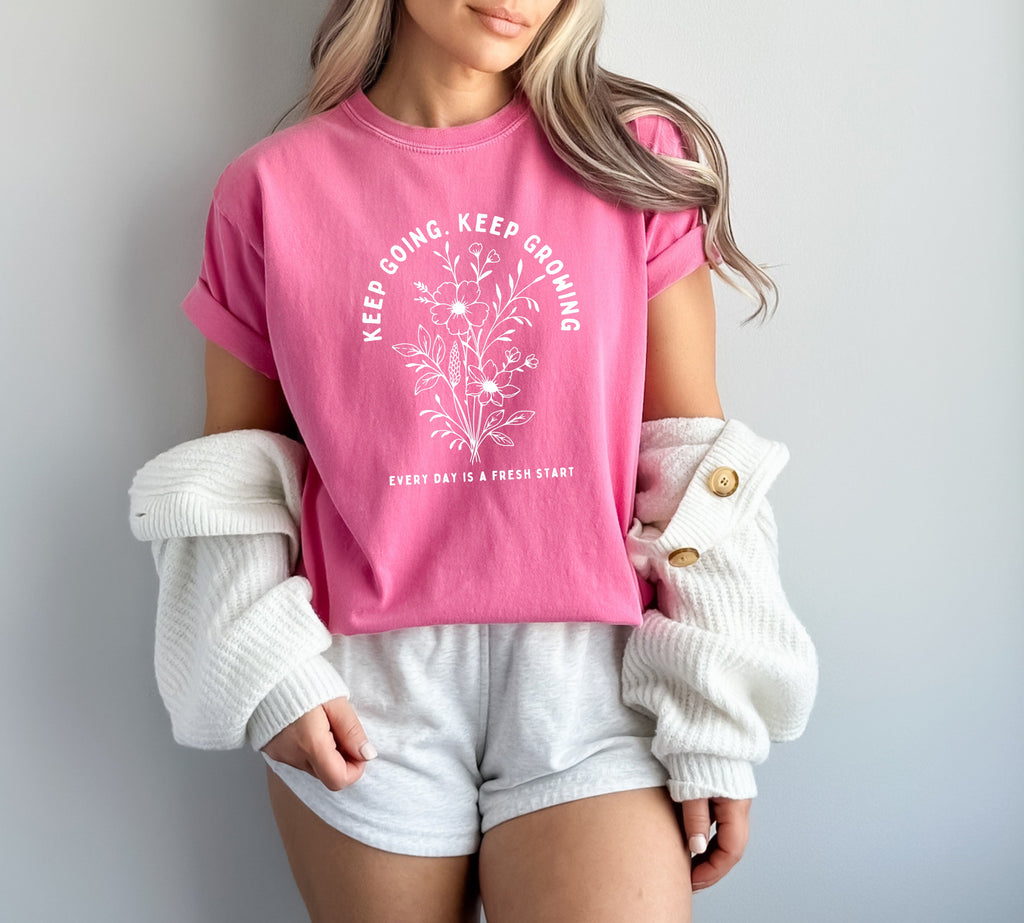 Pink dyed graphic T shirt with floral wreath quote and crew neck