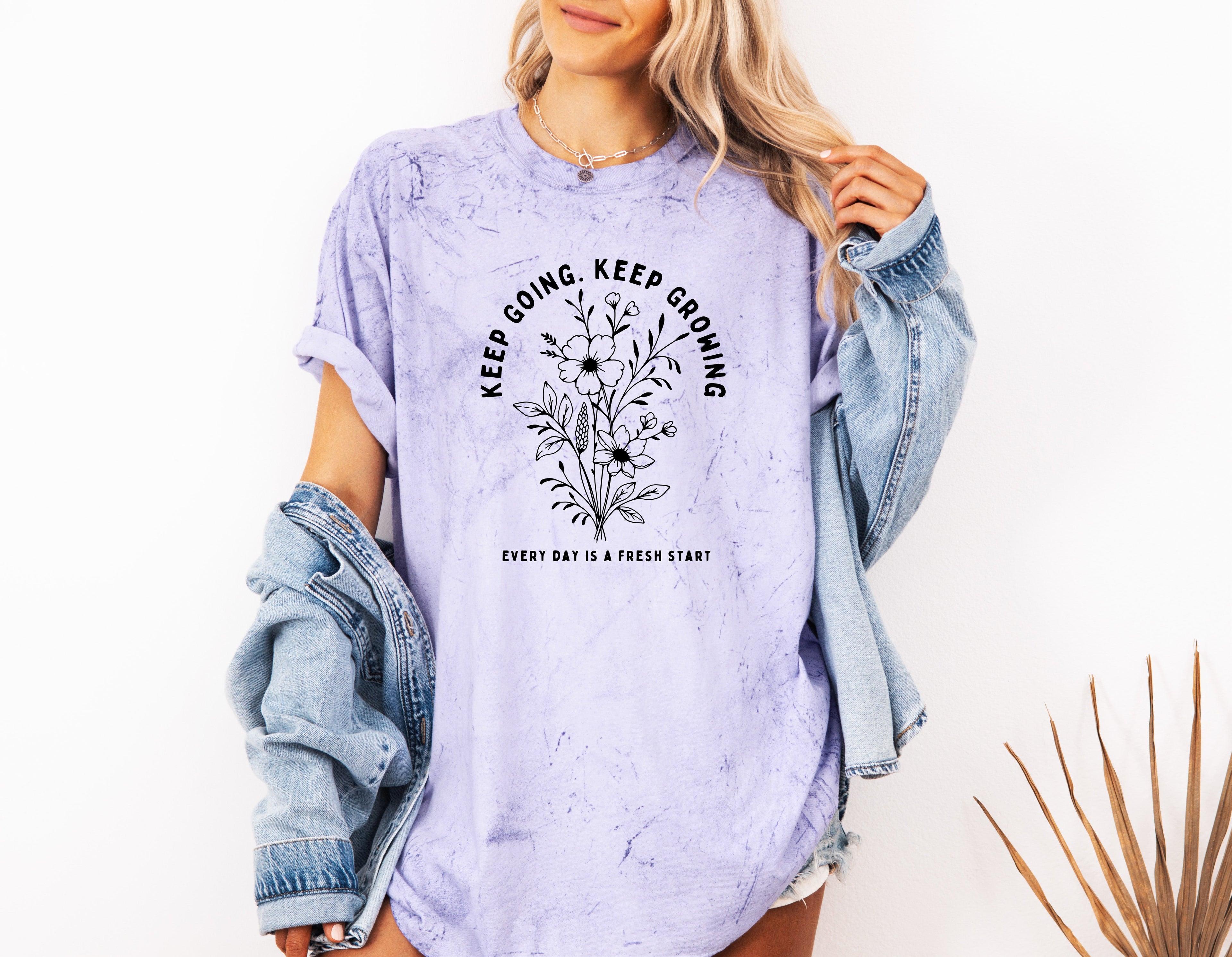 Purple heather dyed graphic T shirt with floral wreath quote and crew neck