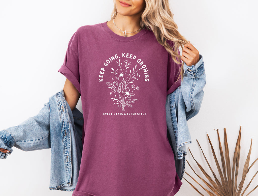 Berry purple unisex T-shirt with white botanical quote graphic on front.