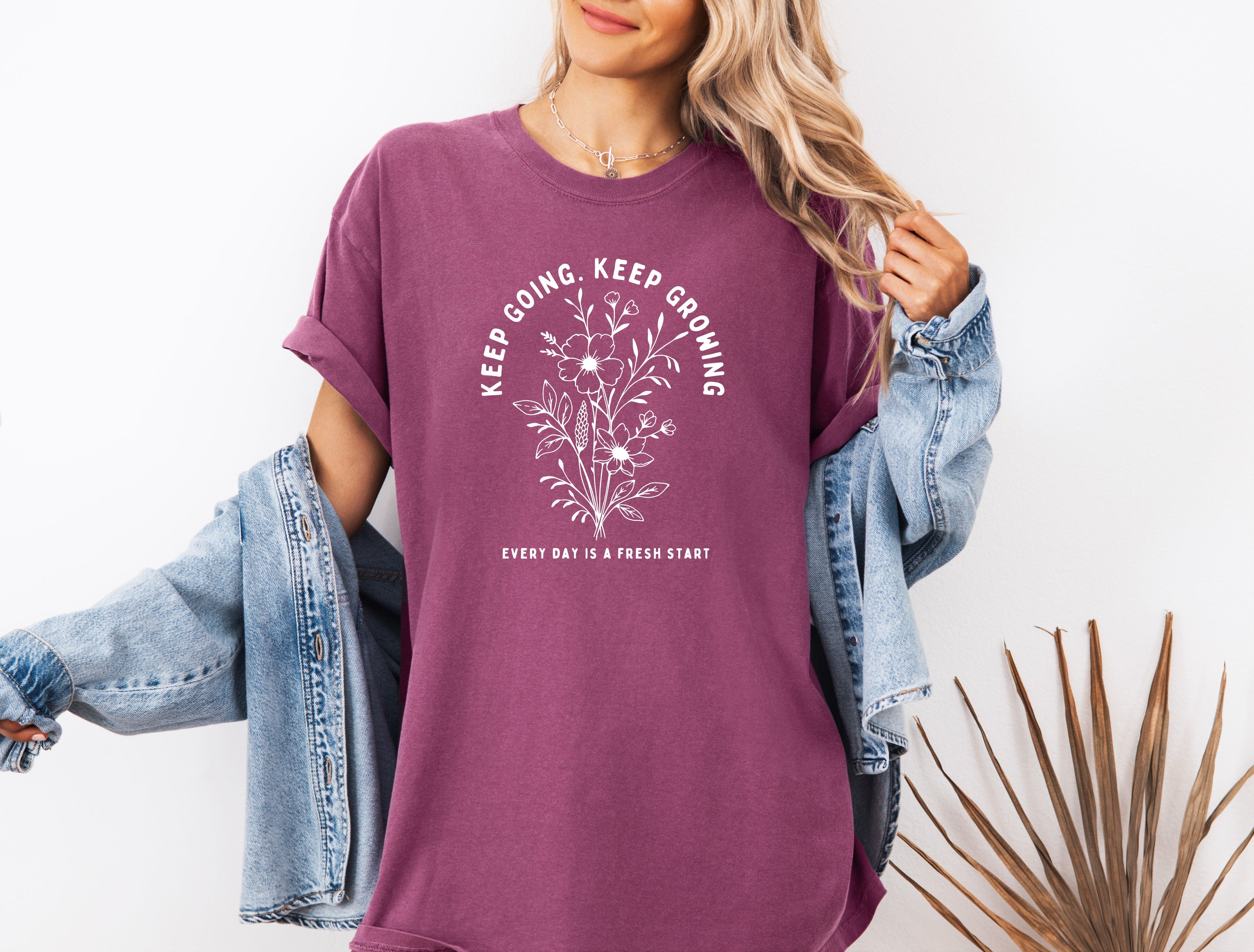Berry purple unisex T-shirt with white botanical quote graphic on front.
