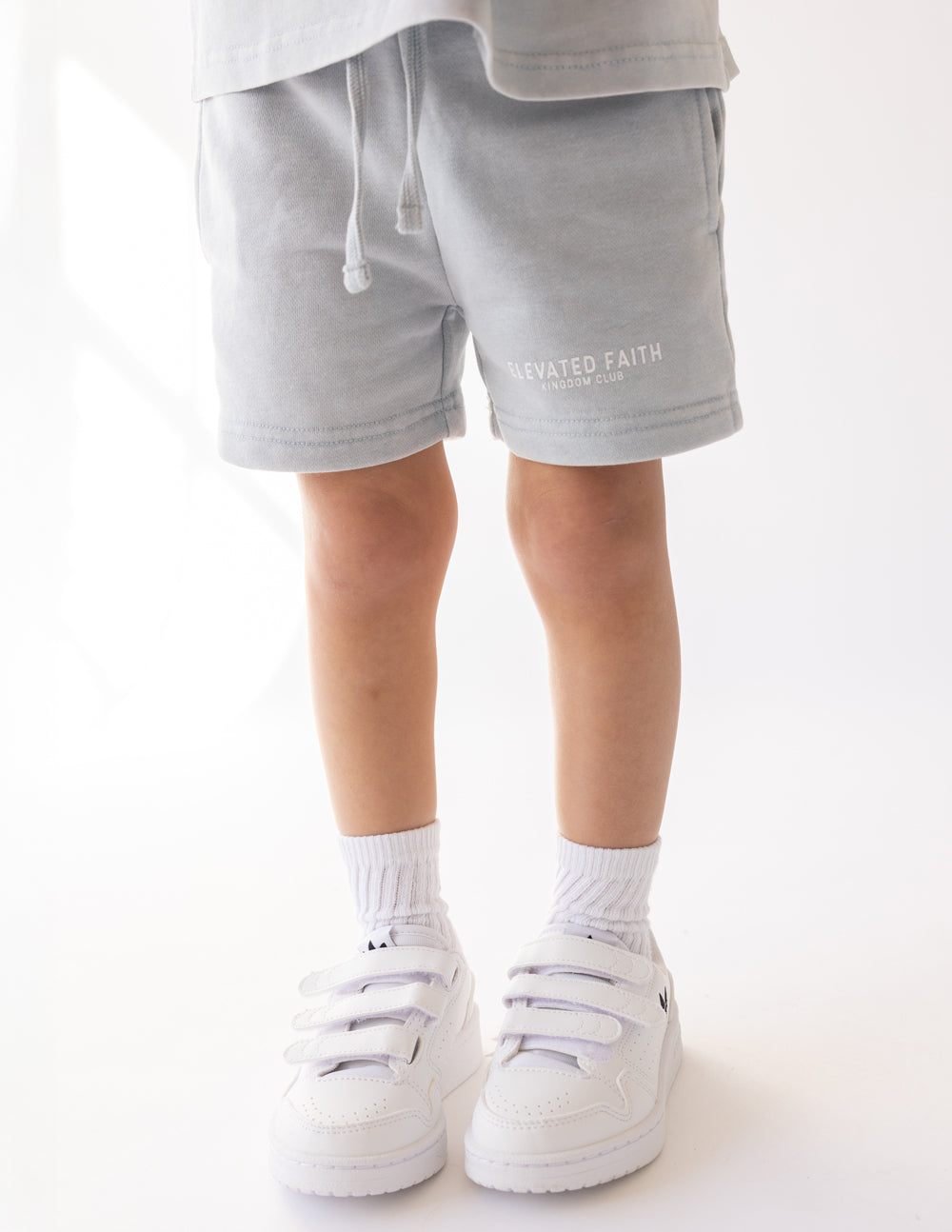 Kids light blue shorts with elastic waist and drawstring, side logo print