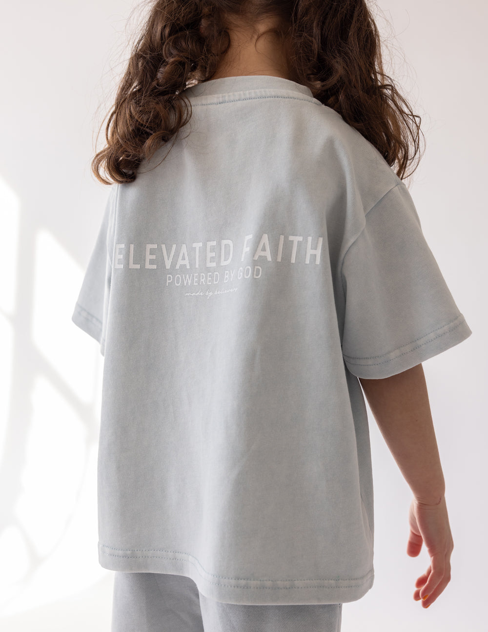 Kids light gray crewneck graphic tee, back text "ELEVATED FAITH"