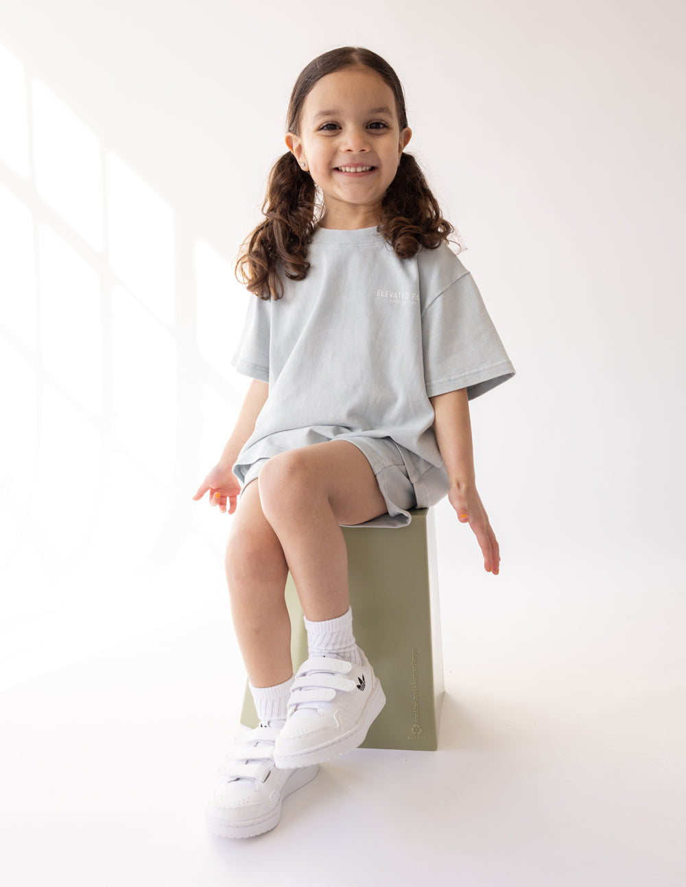 Kids light gray crewneck graphic tee, front logo with "ELEVATED FAITH"