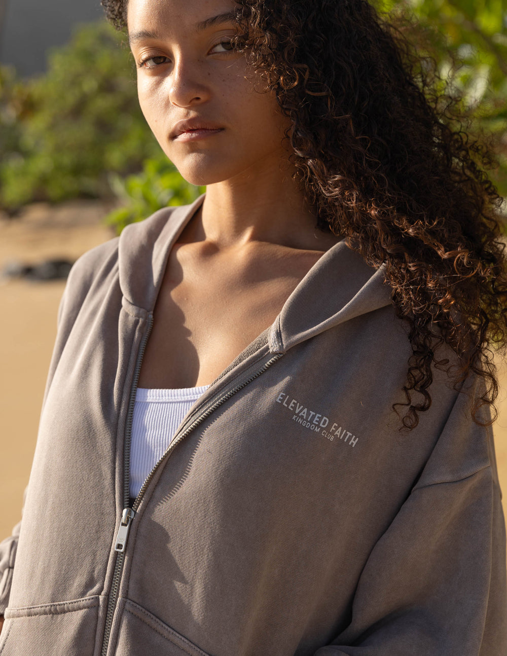 Brown full-zip hoodie close-up with hood and front zipper