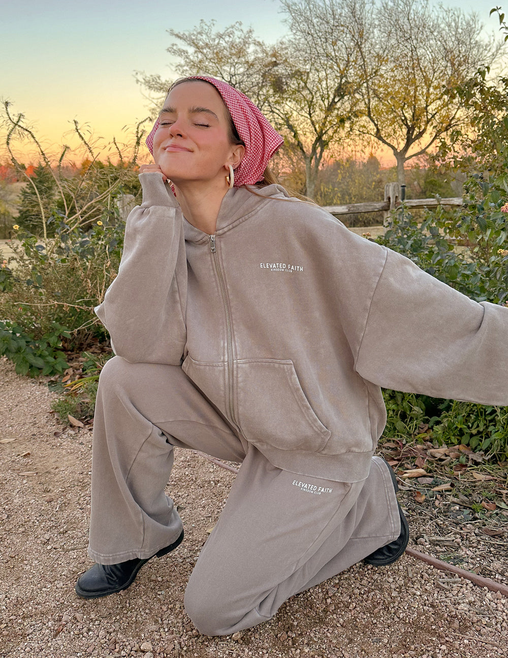 Brown full-zip hoodie with hood, front zipper, and small chest logo