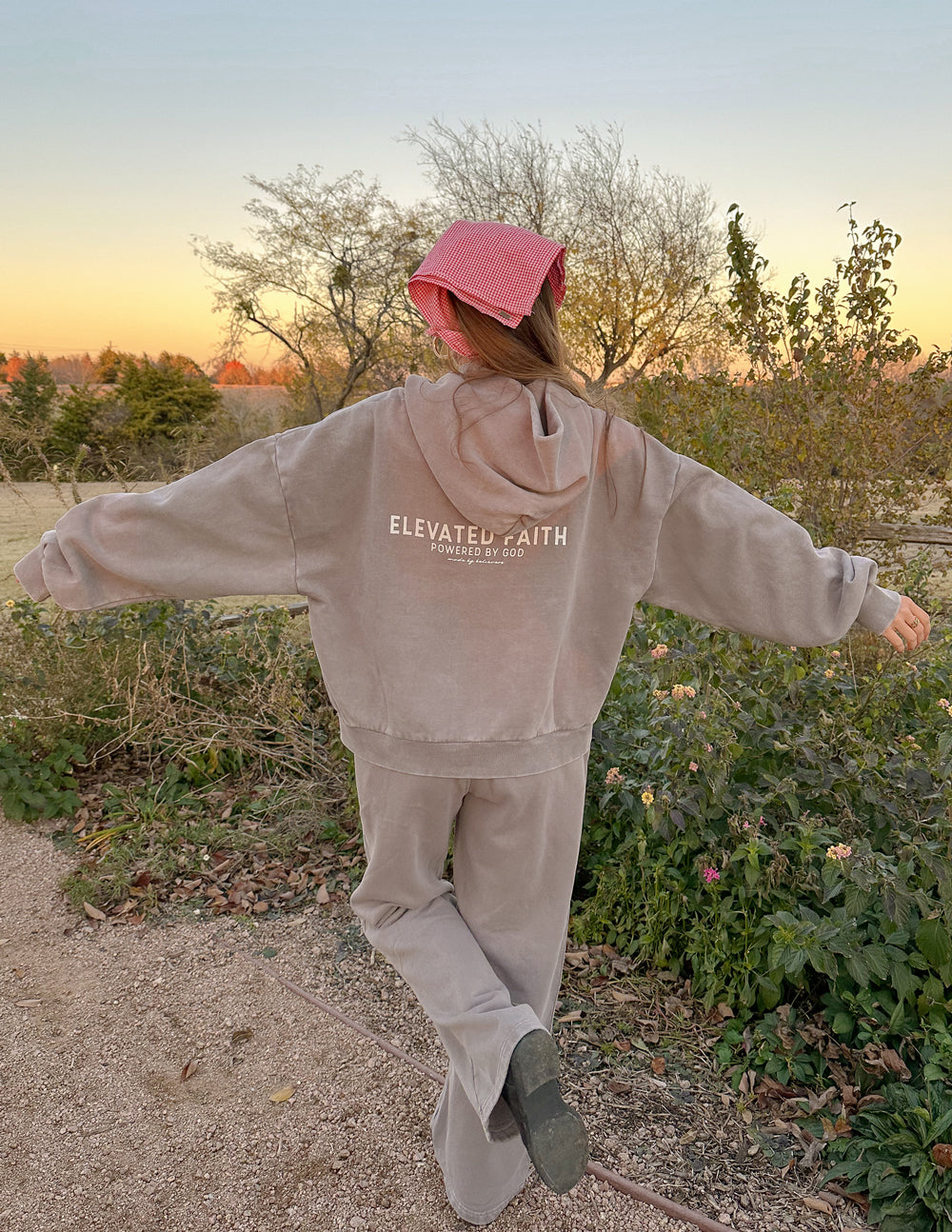 Brown full-zip hoodie back view with hood up and centered logo