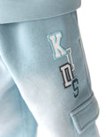 Kids light-blue cargo sweatpants, side graphic patch near cargo pocket