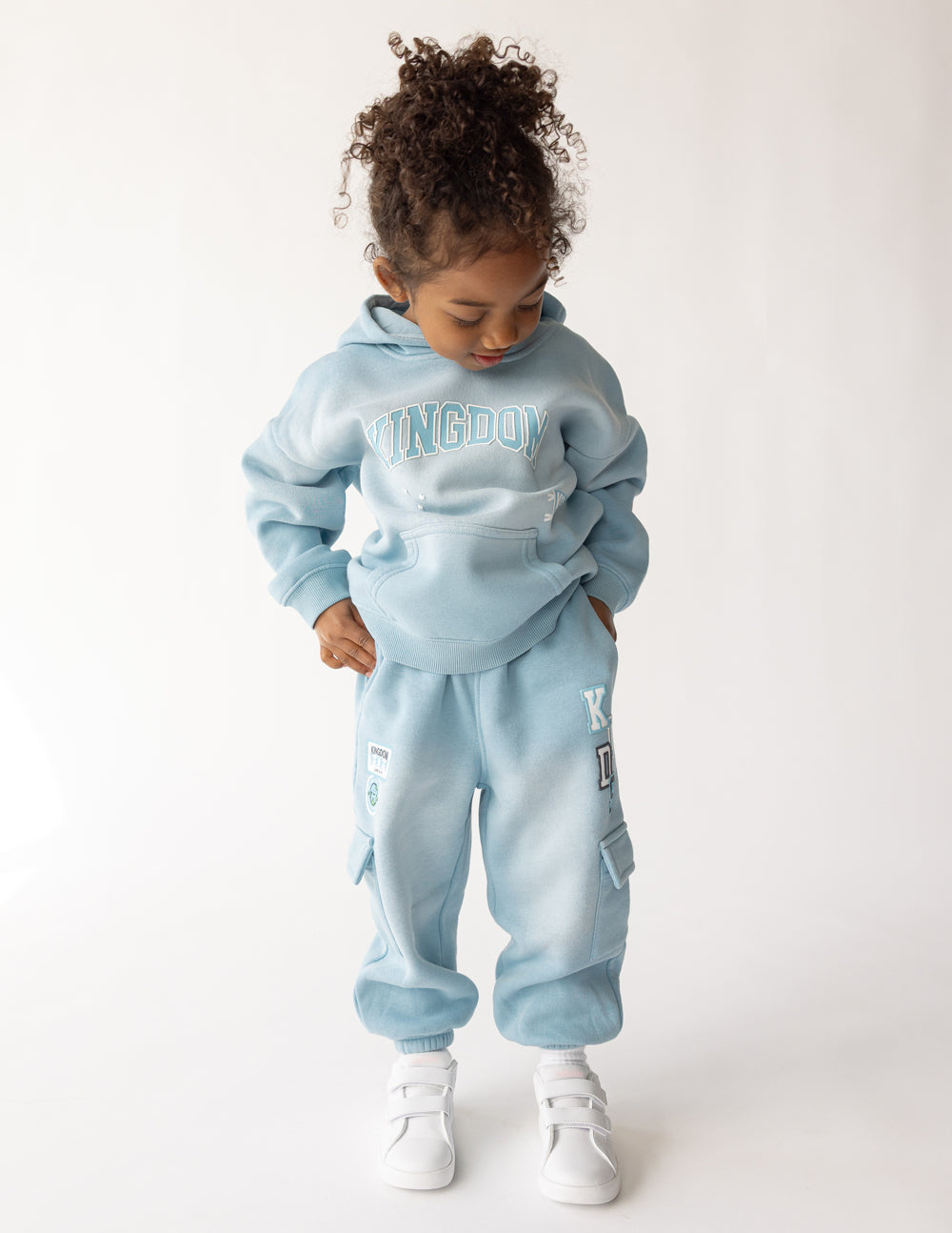 Kids light-blue cargo sweatpants with cargo pocket flap and graphic on leg