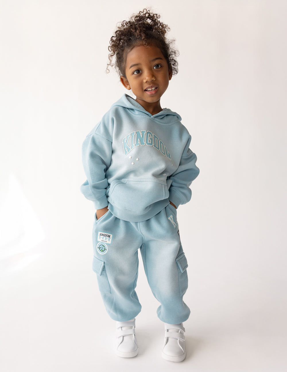 Kids light blue hoodie with hood and kangaroo pocket, large Kingdom graphic on chest