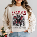 White crewneck sweatshirt with Krampus graphic and 'Is coming to town' text