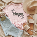 Pale pink T-shirt with 'This teacher prays' graphic print at center