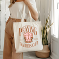 White canvas tote bag with Praying Teachers Club logo front, double handles.