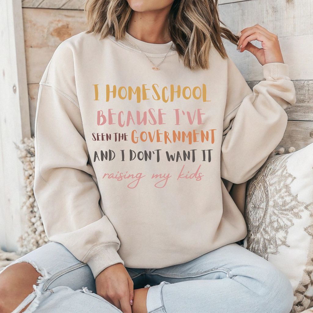 Cream crewneck sweatshirt with 'I HOMESCHOOL' front graphic text