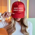 Red trucker cap with white 'MAKE JESUS GREAT AGAIN' lettering