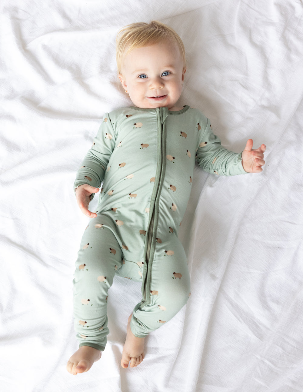 Sage green lamb-print convertible footed baby onesie with front zip and cuffs