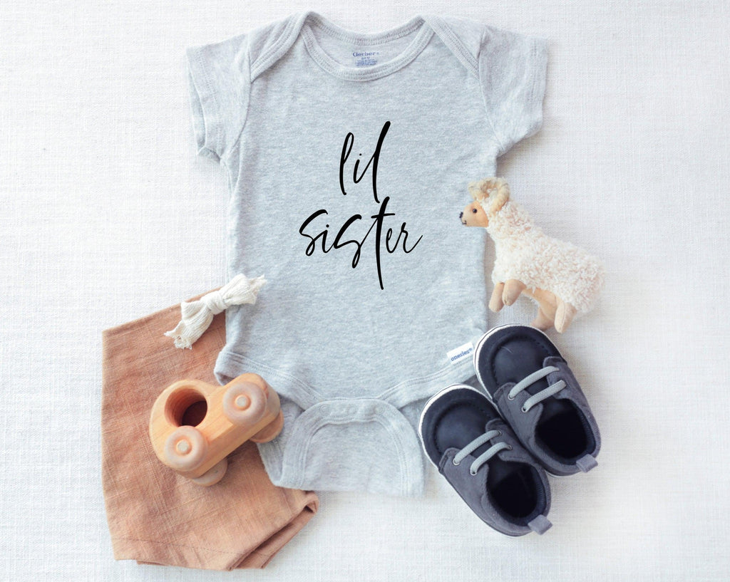Heather gray baby bodysuit with black cursive "lil sister" print
