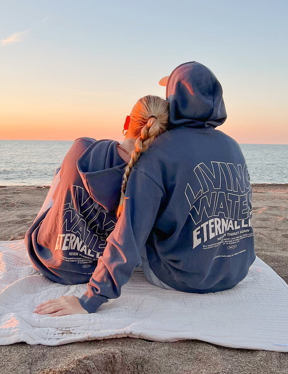 Dark blue hoodie back with Living Water Eternal Life graphic and hood.