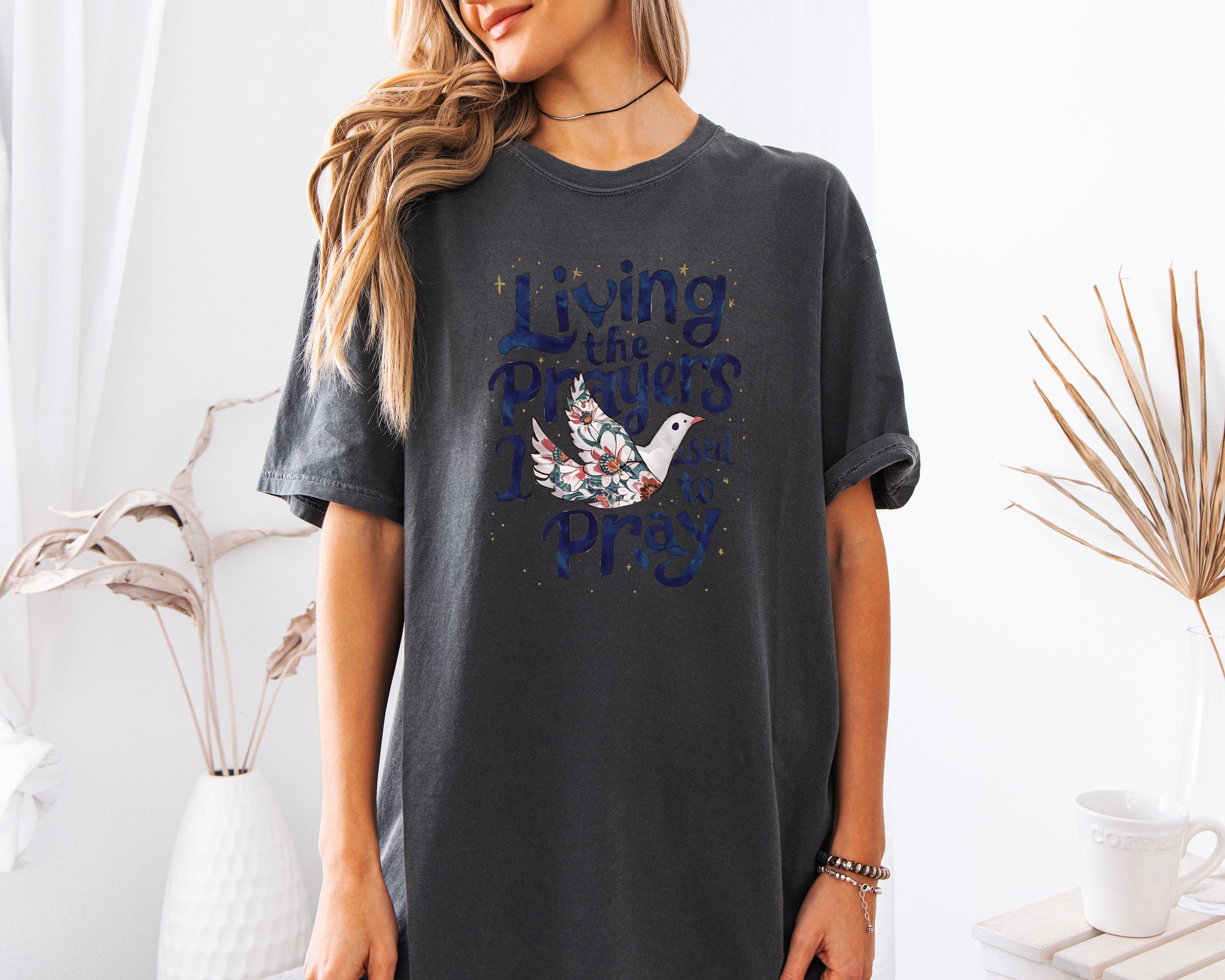 Dark gray unisex t-shirt with “Living the Prayers…Pray” front graphic